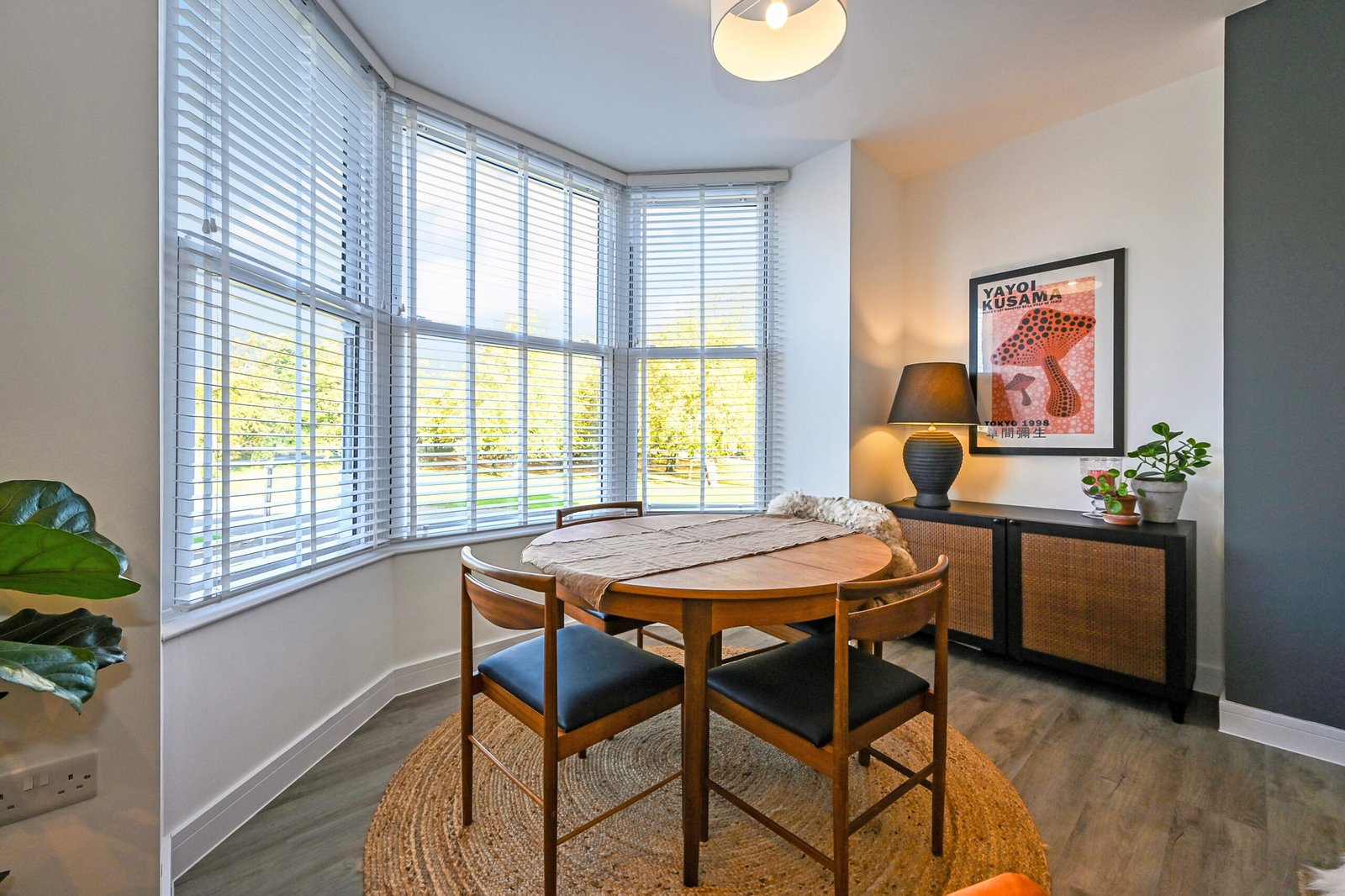 Photograph of a dining table infront of a bay window